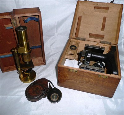 Lot 1029 - A Lacquered Brass Drum Microscope, with rack & pinion focusing, convex mirror, on a circular...