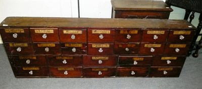 Lot 1043 - A Victorian Pine Drug Run, with fourteen small drawers over ten larger drawers, gilt and black...