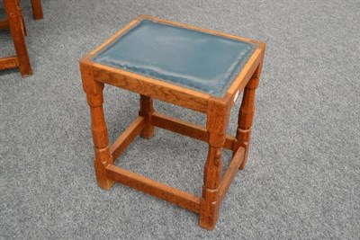 Lot 831 - A Robert Mouseman Thompson Oak Stool, with blue hide seat, on four octagonal legs joined by...