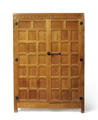 Lot 832 - A Robert  "Mouseman " Thompson 4ft Panelled Oak Wardrobe, with half penny moulding above two doors