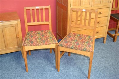 Lot 840 - A Pair of Robert  "Mouseman " Thompson Bespoke Oak Bedroom Chairs, with slatted backs, on four...