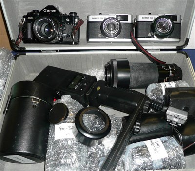 Lot 1176 - A Collection of Cameras and Accessories, including two Olympus Trip 35's, Canon A-1 in black...