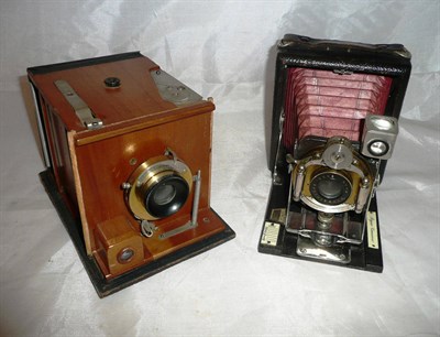 Lot 1184 - A Kodak No.2 Bulls Eye Special Camera, with black leather covered wooden body, polished teak...