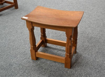 Lot 845 - A Robert  "Mouseman " Thompson Oak Dish Top Stool, on four octagonal legs joined by stretchers,...