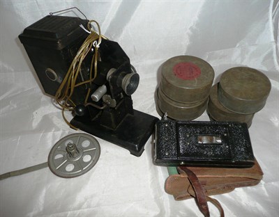 Lot 1211 - A Tinplate Projector, with eleven 35mm films in tin canisters, some labelled 'Cinema Films',...