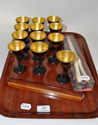 Lot 23 - Set of twelve lacquered goblets decorated with cockerels, carved ivory glove stretchers in original