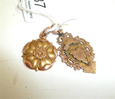 Lot 87 - A 9ct gold medal and a rose fob