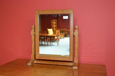 Lot 858 - A Robert  "Mouseman " Thompson Oak Stand Mirror, the rectangular mirror pivots between two...