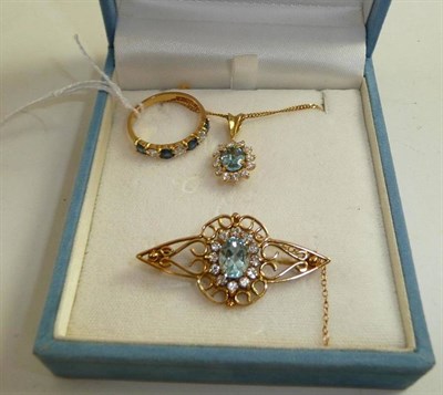 Lot 110 - A sapphire and diamond seven stone ring, an aquamarine brooch and pendant