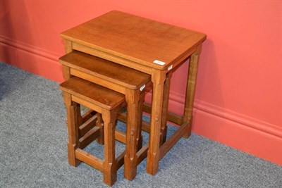 Lot 860 - A Robert  "Mouseman " Thompson Oak Nest-of-Tables, on four octagonal legs, each with carved...