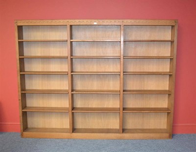 Lot 863 - A Robert  "Mouseman " Thompson Bespoke Oak Bookcase, the castellated top above three open...