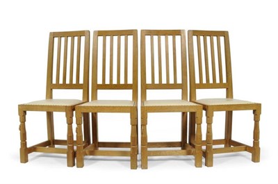 Lot 867 - A Set of Four Robert  "Mouseman " Thompson Millennium Range Oak Dining Chairs, with curved back...