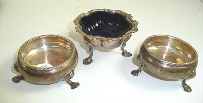 Lot 228 - Silver salt on tripod feet with blue glass liner and a pair of Georgian silver salts (3)