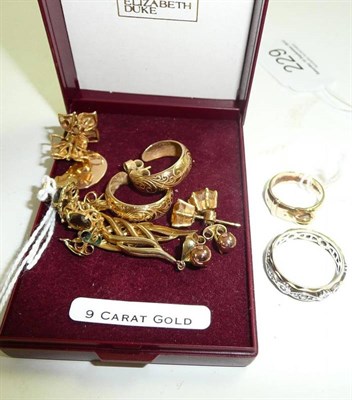 Lot 229 - A 9ct gold buckle ring, a diamond set initial 'D' pendant, assorted earrings and an eternity ring