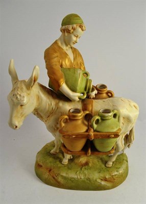 Lot 294 - Royal Dux donkey carrying four water urns with boy pouring water into one