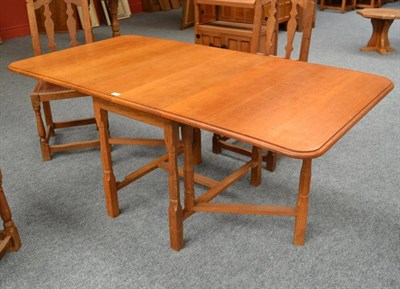 Lot 877 - A Derek  "Lizardman " Slater Oak Drop-Leaf Dining Table, the rectangular top with drop ends, on six