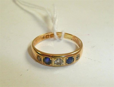 Lot 306 - An 18ct gold diamond and sapphire ring