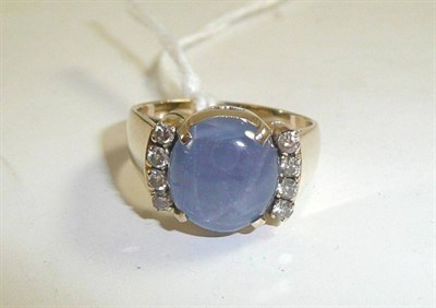 Lot 310 - A star sapphire and diamond ring, stamped '18K'