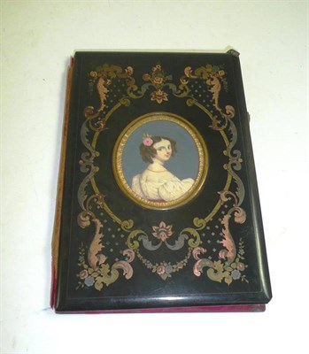 Lot 324 - A Victorian papier mache notebook cover set in a portrait miniature of young girl, inlaid with gilt