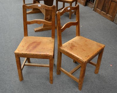 Lot 882 - A Set of Four Kingpost Woodwork Oak Chairs, with shaped rail backs, on four square section legs...