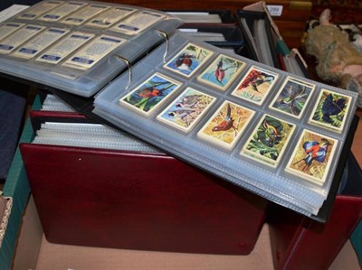 Lot 393 - A collection of cigarette card sets and odds, in nine albums and a box and trade card