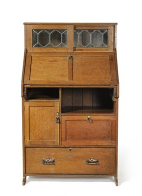 Lot 892 - A Stanley Webb Davies Oak Writing Desk, 1912, the upper section with two leaded glazed sliding...