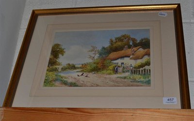 Lot 457 - Gilt framed watercolour depicting figures on a path by a thatched cottage, signed Arthur Mills