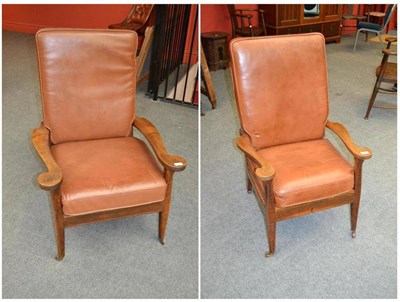 Lot 893 - A Pair of Arthur W Simpson of Kendal Oak and Leather Armchairs, the curved nailed leather backs...