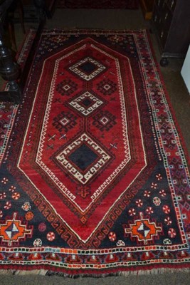 Lot 474 - Kashgai rug South West Persia, The crimson lozenge field enclosed by hooked motif borders, 273...