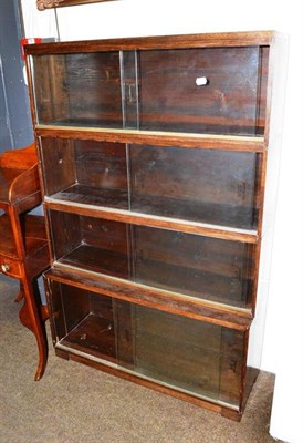 Lot 481 - An oak four height stacking bookcase with sliding glass doors