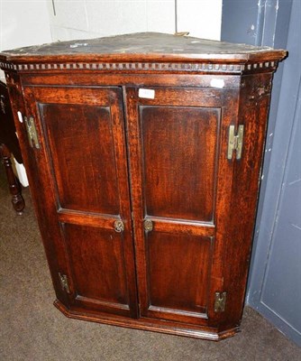 Lot 483 - A 19th century oak corner cupboard