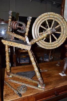 Lot 596 - An 18th century polychrome painted spinning wheel, Low Countries, decorated overall with floral...