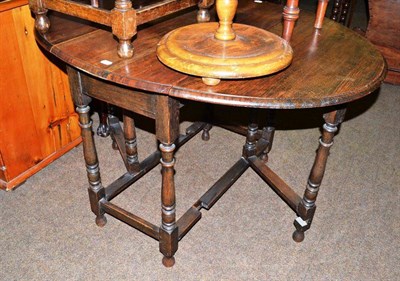 Lot 607 - A mahogany bow front china glazed cabinet and an oak drop leaf table