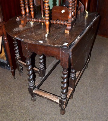 Lot 611 - A 19th century oak drop leaf table