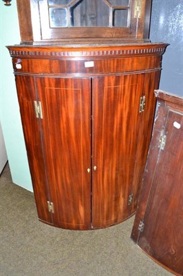 Lot 615 - A late 18th century mahogany bow fronted wall hanging corner cabinet