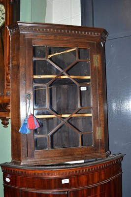 Lot 616 - A oak glazed hanging corner cabinet