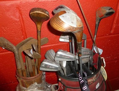 Lot 658 - Nine hickory-shafted golf clubs in a canvas bag and a bag of steel-shafted clubs and golf shoe bag