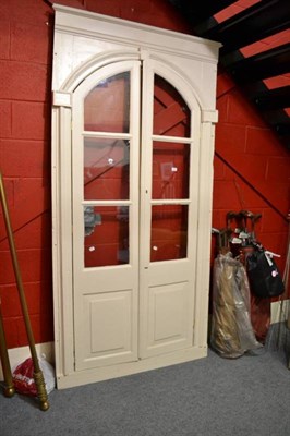 Lot 659 - Stripped pine fire surround and a cream painted glazed doors and frame and two brass curtain poles