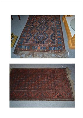 Lot 695 - Balouch rug Persian/Afghan frontier, the honeycomb lattice field of hooked motifs enclosed by...