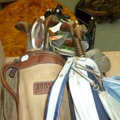 Lot 732 - Two bags of assorted golf clubs, various tennis rackets, hockey sticks, rubber decoy birds etc