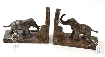 Lot 936 - A Pair of Spelter and Marble Elephant Bookends, 20th century, as standing elephants, on rectangular