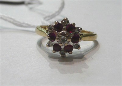 Lot 42 - An 18ct gold three row diamond and ruby cluster ring