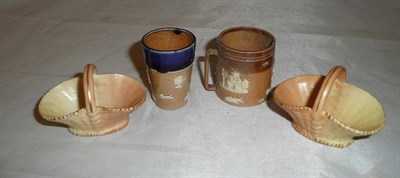 Lot 162 - Two miniature Royal Worcester blush ivory baskets, Royal Doulton miniature tyg and a beaker (4)