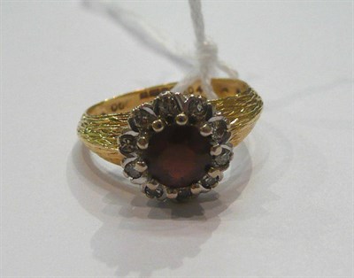 Lot 168 - An 18ct gold garnet and diamond cluster ring