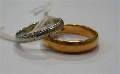 Lot 171 - A 22ct gold band ring and an 18ct white gold band ring