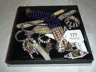 Lot 177 - A box of costume jewellery, three brooches and a clip, four mother of pearl penknives, costume...