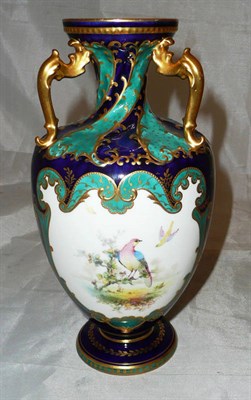 Lot 222 - A Royal Crown Derby vase painted with a vignette of birds by C Harris over a blue ground