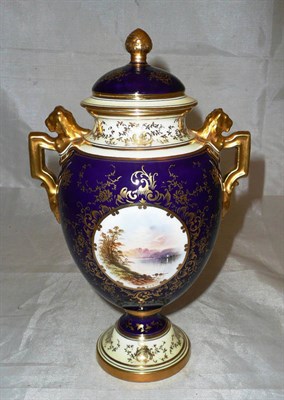 Lot 224 - A Coalport twin handled urn and cover painted with a vignette by E Ball