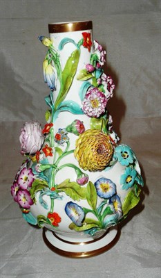 Lot 229 - A porcelain vase encrusted with flowers