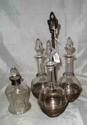 Lot 238 - A Victorian silver decanter stand with three decanters and a silver mounted decanter